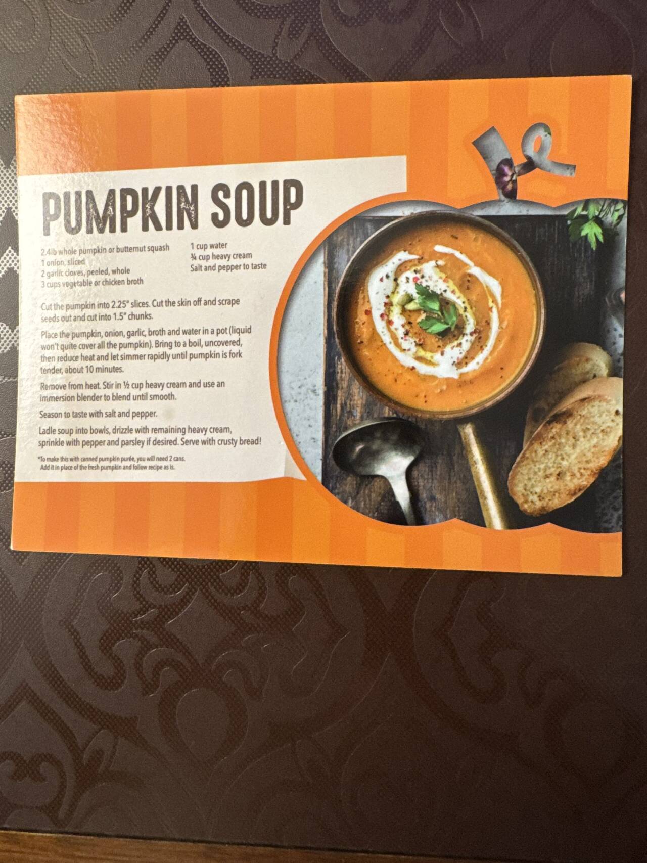 An orange Pumpkin Soup recipe card with a bowl of soup and crusty bread